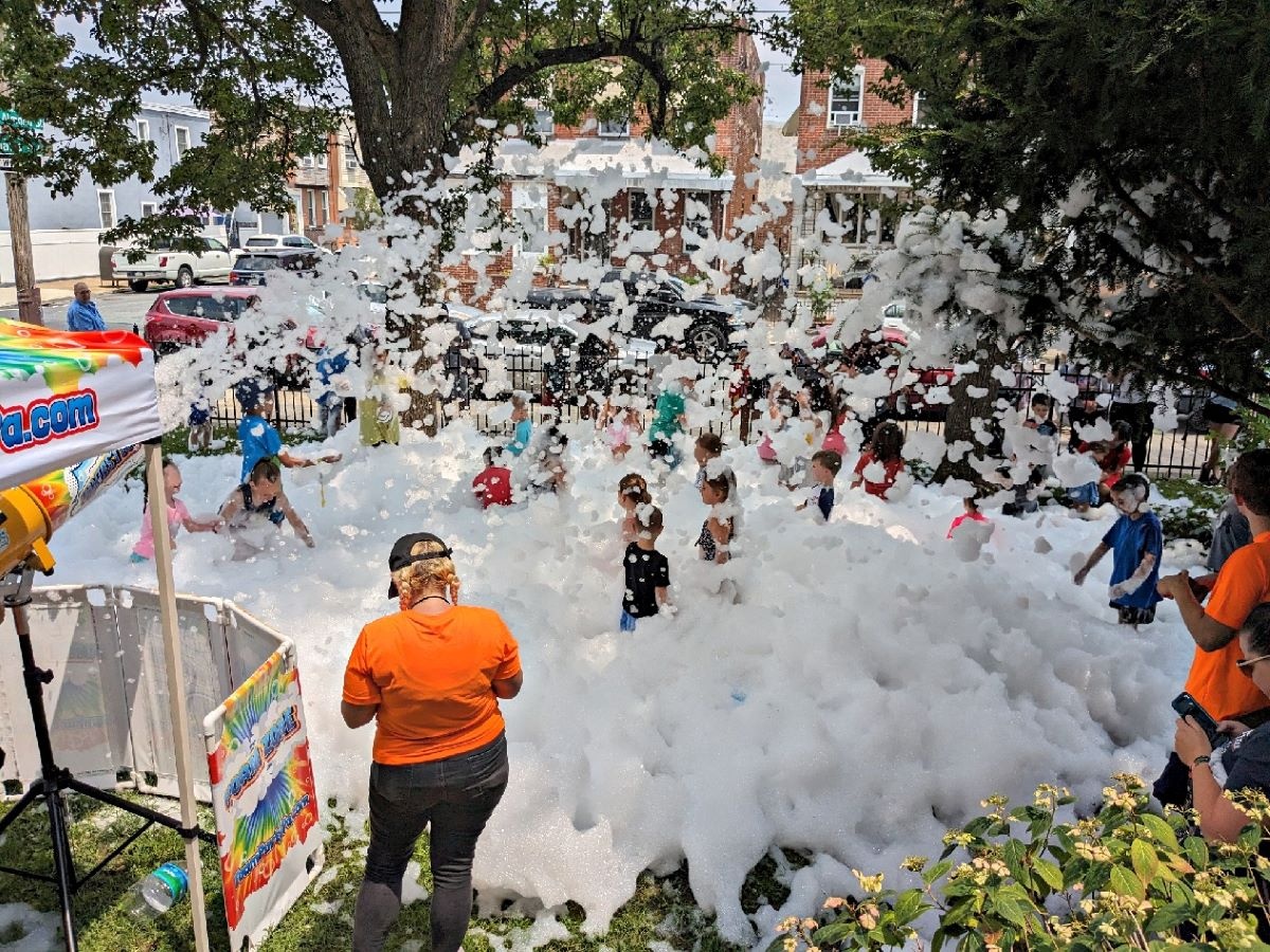children outdoors playing in foam