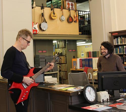 Music Department Librarian Perry Genovesi enjoying a personal concert from Nels Cline, as he plays one of the circulating guitars & amps from our Musical Instrument Collection.