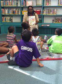 Christina reading to children during a storytime event.