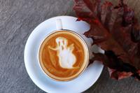 An autumn coffee cup with a foamy ghost