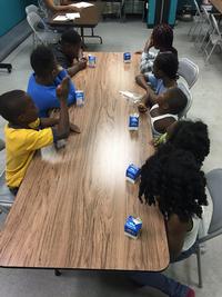 Children eating fresh daily meals, provided through the Summer Food Service Program (SFSP)