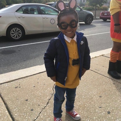 A young library patron poses, dressed as children's book character Arthur.