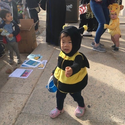 Toddlers in bee and lion costumes attend the costume parade at Parkway Central Library.