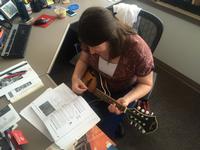 Strumming away with the help of guidebooks from the Music Department