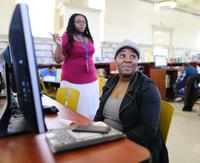Helping patron with Job Readiness computer resources (photo credit: Philadelphia Inquirer)