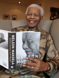 Nelson Mandela with his book Conversations with Myself