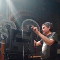 Jay Schwartz works the projectors at a screening at Fleisher Art Memorial. (Photo by Silvia Hortelano-Pelaez.) 