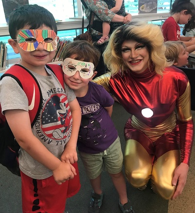 These children and superheroes are enjoying a recent Drag Queen Storytime!