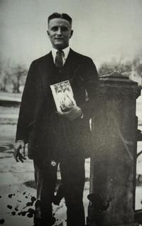 F. Scott Fitzgerald holding a copy of The Great Gatsby