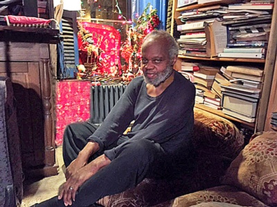 A portrait of Grimes at home in 2015, posted in the announcement of his passing by his widow, Margaret Davis-Grimes, whose writings at henrygrimes.com made this blog post possible. Photo by Aksel Theilkuhl.