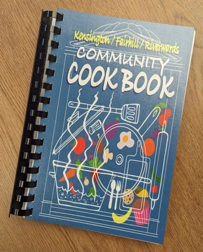 Copy of The Kensington, Fairhill, Riverwards Community Cookbook resting on a tabletop