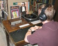 A patron listening to an LP on one of our turntables