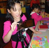 A young attendee uses an iPad to create images for stop motion animation.