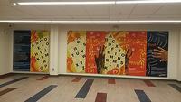 Visitors to the recently-renovated Logan Library can also find Trapeta’s verse beautifully painted on the wall of the Community Room as part of a mural by Ife Nii Owoo.